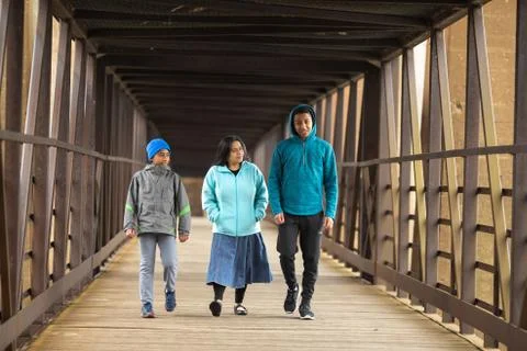 Hispanic Mother Walks With Sons On A Bridge Stock Photos