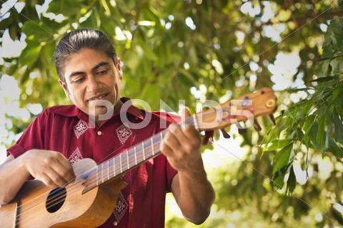 Hispanic Musician Performing In Park