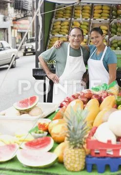 Hispanic People Working At Fruit Stall