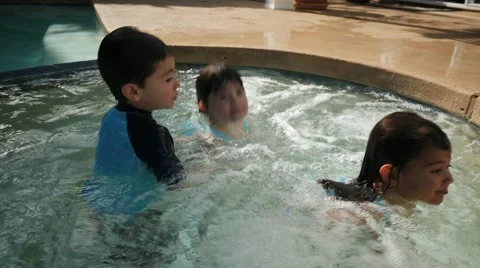 HISPANIC SIBLINGS PLAY IN A JACUZZI. Video stock 54621976