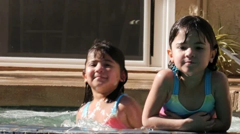 HISPANIC SISTERS PLAY IN POOL IN SLOW MOTION Stock Footage 54621888