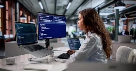Hispanic Software Engineer Coding Secure Web Applications In Modern Office. Stock-Fotos