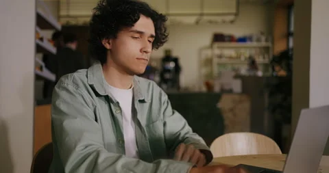 Hispanic Student Of IT Faculty Sitting With Laptop In Cozy City Cafe, Dolly Shot Stock Footage 276846029