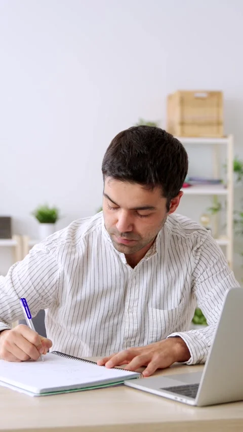 Hispanic student watching tutorial on laptop Stock Footage 263995288