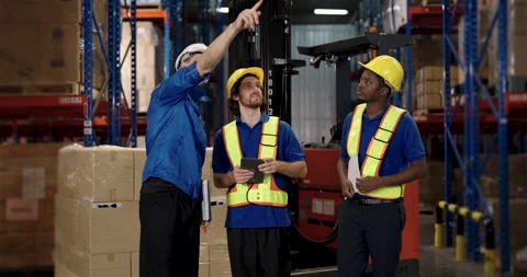 Hispanic supervisor directs asian subordinate trio formulating work plan Stock Footage 310389191