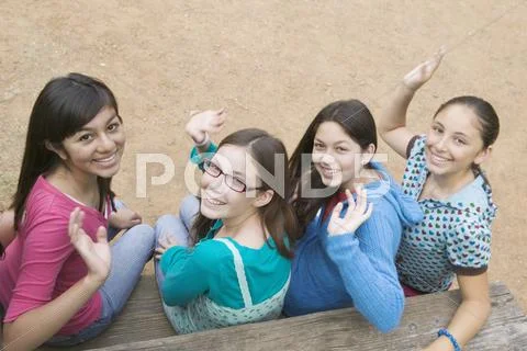 Hispanic teenaged girls waving Stock Photos