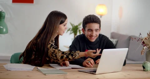 Hispanic teenagers actively explaining school research exercises studying at Stock Footage 120946530
