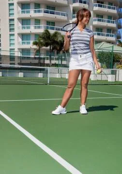 Hispanic tennis player holding racket and ball Stock Photos