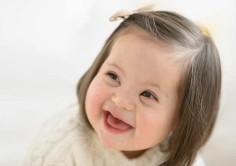 Hispanic toddler with Down syndrome laughing Stock Photos