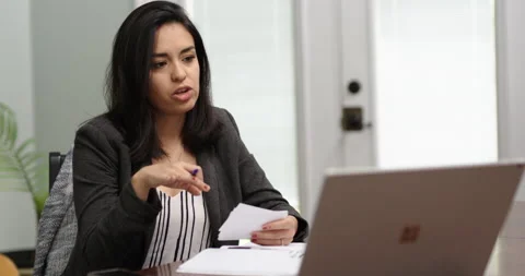 Hispanic Woman Behind Computer attending Virtual Meeting Stock Footage