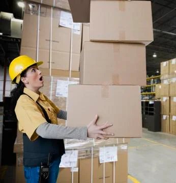 Hispanic woman carrying stack of boxes Stock Photos
