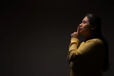 Hispanic Woman Commanding Silence Using Gesture with Finger Stock Photos