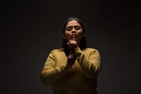 Hispanic Woman Commanding Silence Using Gesture with Finger Stock Photos
