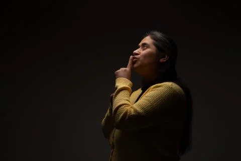 Hispanic Woman Commanding Silence Using Gesture with Finger Stock Photos