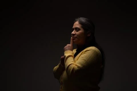 Hispanic Woman Commanding Silence Using Gesture with Finger Stock Photos