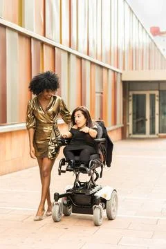 Hispanic woman with a disability, motor wheelchair user celebrate New Year Eve Stock Photos