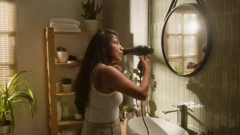 Hispanic Woman Drying Her Long Hair with Blow Dryer in Bathroom Stock-Footage 342722103