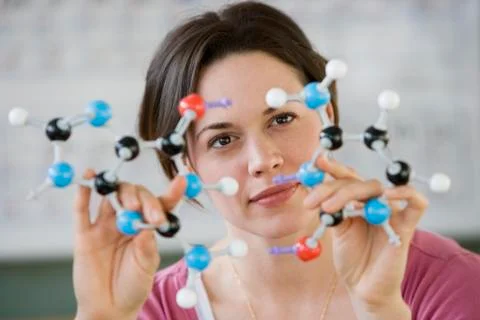 Hispanic woman holding molecular model Stock Photos