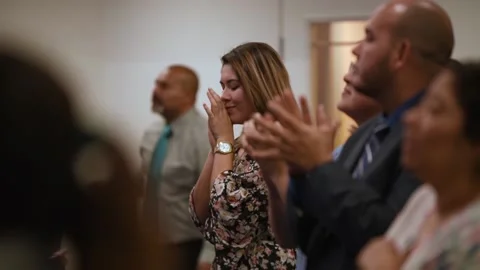 Hispanic woman praying with joy wide shot Stock Footage