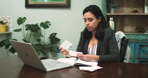 Hispanic Woman Presenting Virtually with Notecards Video stock 131571624