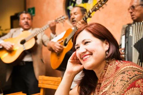 Hispanic woman in restaurant with traditional band Stock Photos