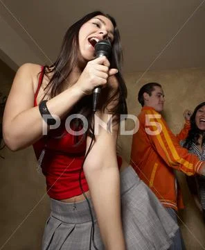 Hispanic Woman Singing With Microphone