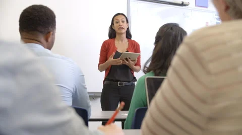 Hispanic woman with tablet teaching adult education class Stock Footage