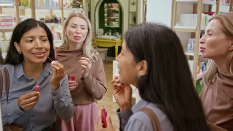 Hispanic Woman Testing Liquid Lipstick in Cosmetics Store Stock Footage 345504203