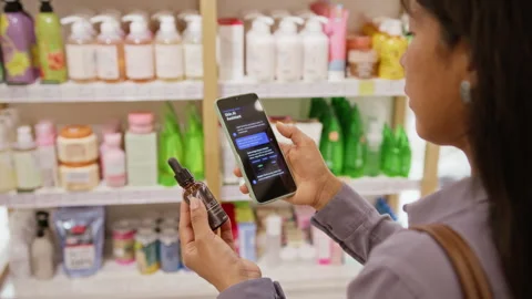 Hispanic Woman Using Ai Assistant on Smartphone for Skincare Shopping Stock Footage 345506058