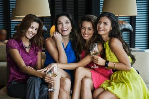 Hispanic women drinking white wine Stock Photos