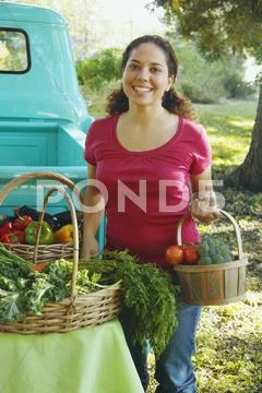 Hispanic women at organic farm stand Stock Photos