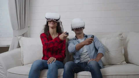 Hispanic young couple wearing virtual reality headsets playing a tennis game Stock Footage 166038232