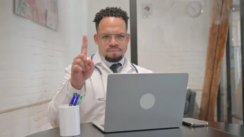 Hispanic Young Doctor Denying while Looking at Camera Stock Footage 305737011