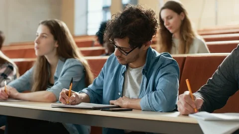 Hispanic Young Man Among His Fellow Students in the Classroom. Stock Footage