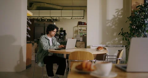 Hispanic Young Man Freelancer Working With Laptop In Cafe In Daytime, Student Stock Footage 276846238