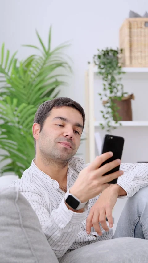 Hispanic young man having video call on phone Stock Footage 262687020