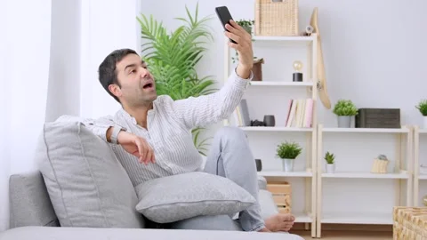 Hispanic young man having video call on phone Stock Footage 263930006