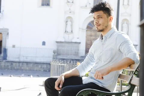 Hispanic young man sitting in front of the San Jose cathedral Antigua Guatemala Foto stock