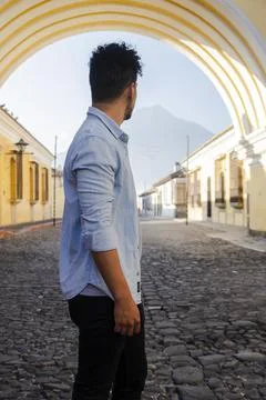 Hispanic young man  under the Arch of Santa Catalina in Antigua Guatemala Stock Photos