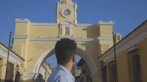 Hispanic young man walking in emblematic street of Antigua Guatemala Stock Footage 147751351