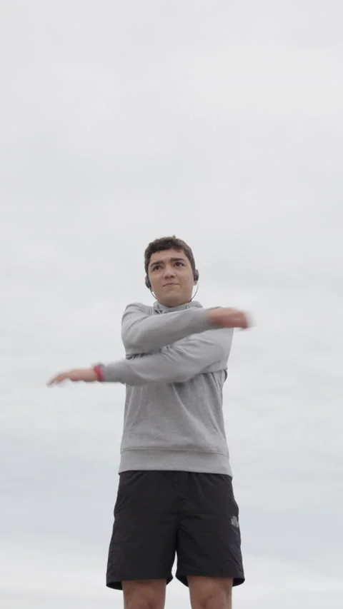 Hispanic young man warming up arms Stock Footage 217372967