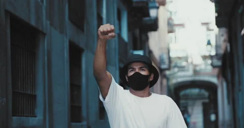 Hispanic young student raised hand with clenched fist up on personal Stock-Footage 140176574