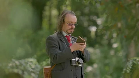 Historian Conducts Research In Graveyard Using Vintage Leather Equipment Video stock 138674206