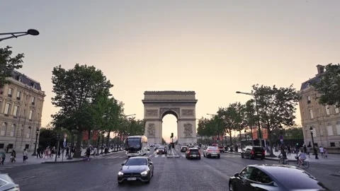 Historic Arc de Triomphe glowing during sunset in central Paris Stock Footage 339914945