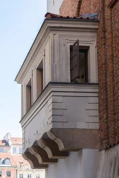 Historic bay window with open frame on old brick building facade in Warsaw Stock Photos