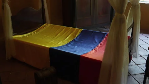 Historic Bed Draped with Colombian Flag Colors, Quinta de San Pedro, Nostalgic Stock Footage 342982188