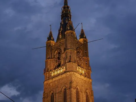 Historic bell tower at night, dramatic lighting and sky, Ghent, Belgium, Europe Stock Photos