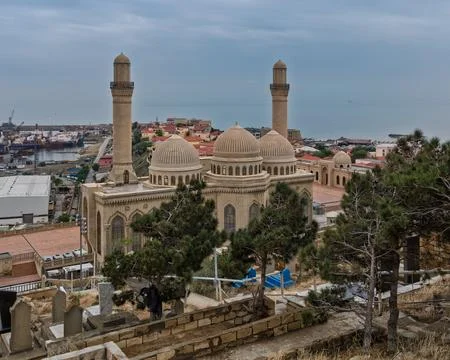 Historic Bibi-Heybat Mosque overlooking the Caspian Sea and port, Baku Stock Photos