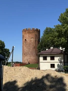 Historic Brick Tower with Surrounding Structures Stock Photos