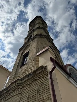 Historic Brick Tower Under a Cloudy Sky Stock Photos